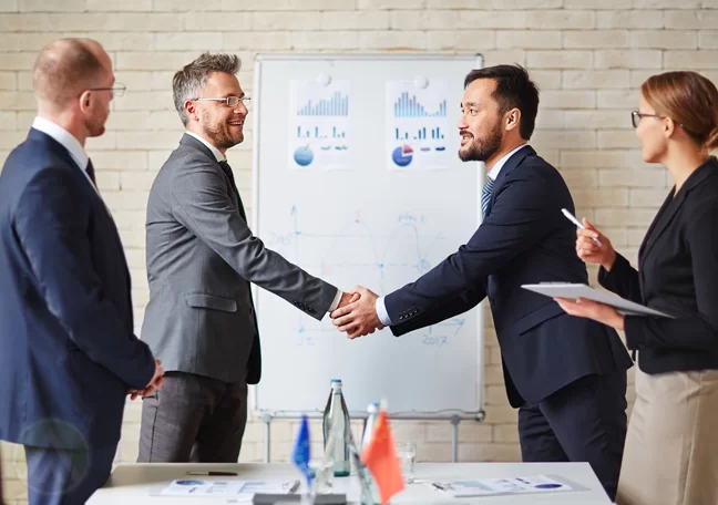 businessman shaking hands foreign business partner