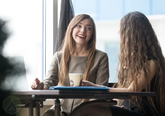 businesswoman talking to customer in coffee shop