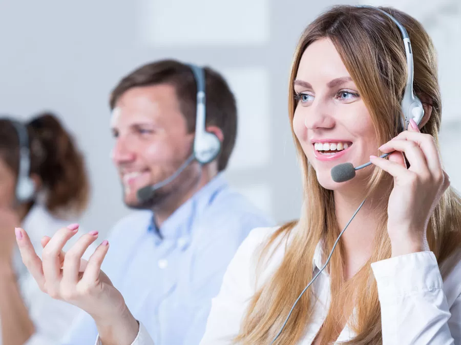 cheerful call center agent with customer care team