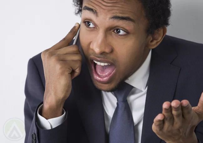 frustrated young man making phone call