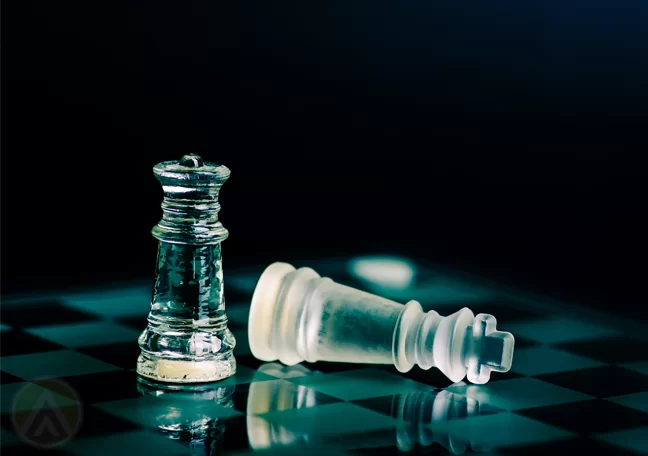 glass chess pieces in dark