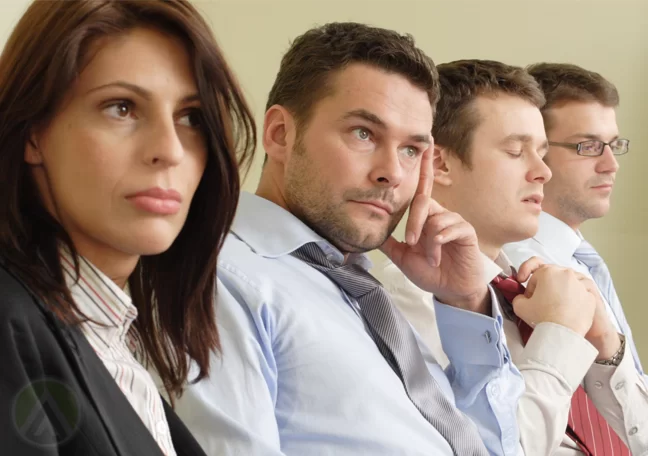 unsure confused sleepy employees in meeting
