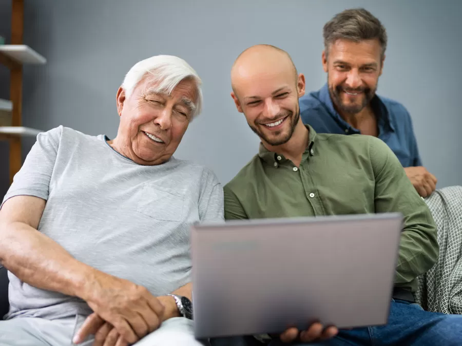 multigeneration grandfather son grandson using laptop for ecommerce online shopping