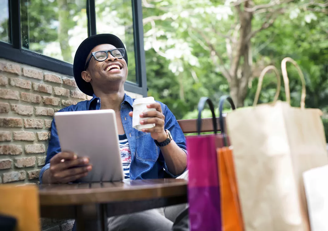 young man with customer care preferences online shopping in coffee shop