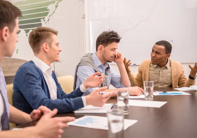 pissed employee annoyed at coworker using phone during office meeting