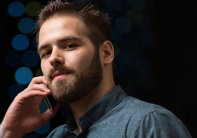 proud arrogant young man making call on smartphone