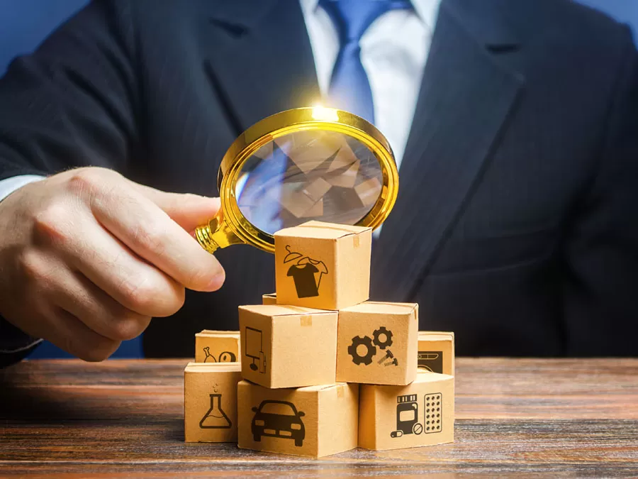 chinese market research depiction business executive looking at wooden blocks through magnifying lens