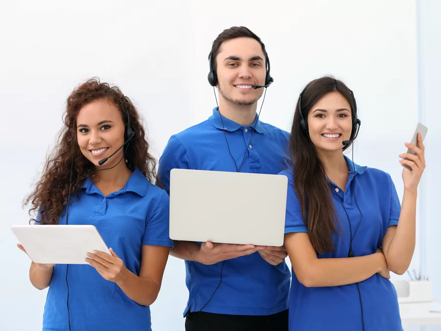multichannel business team in blue in call center using laptop tablet smartphone