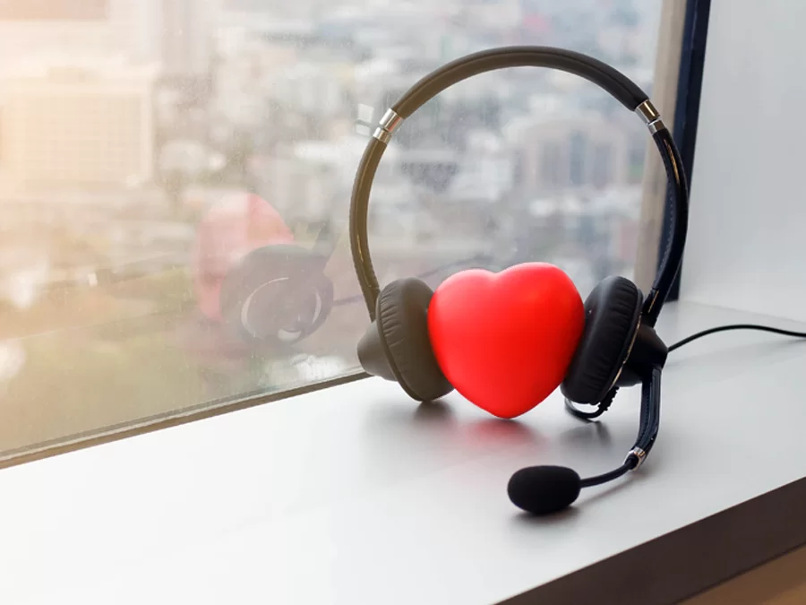 red heart wearing call center headset by a window