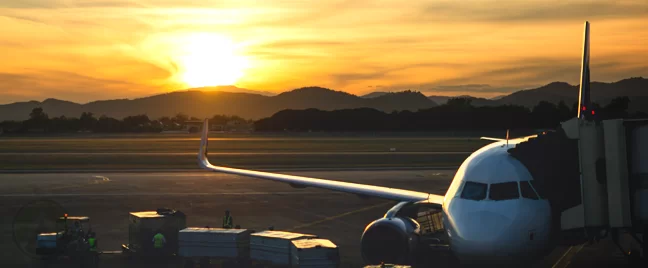 airplane parked in airline at sunset