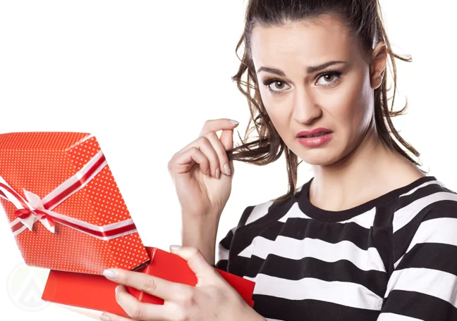 disappointed office worker woman holding gift box 