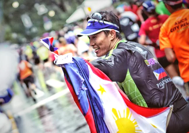 Open Access's BPO Leo Penas at the finish line of the NYC Marathon with Philippine flag