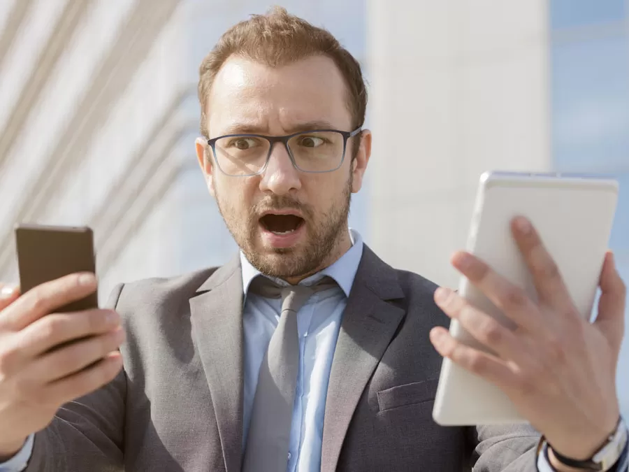 content moderation services depiction businessman shocked surprised looking at illegal activities on laptop table