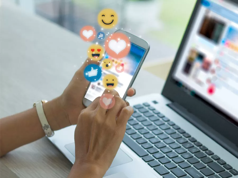 social media customer service depiction social web user on smartphone laptop like heart react icons