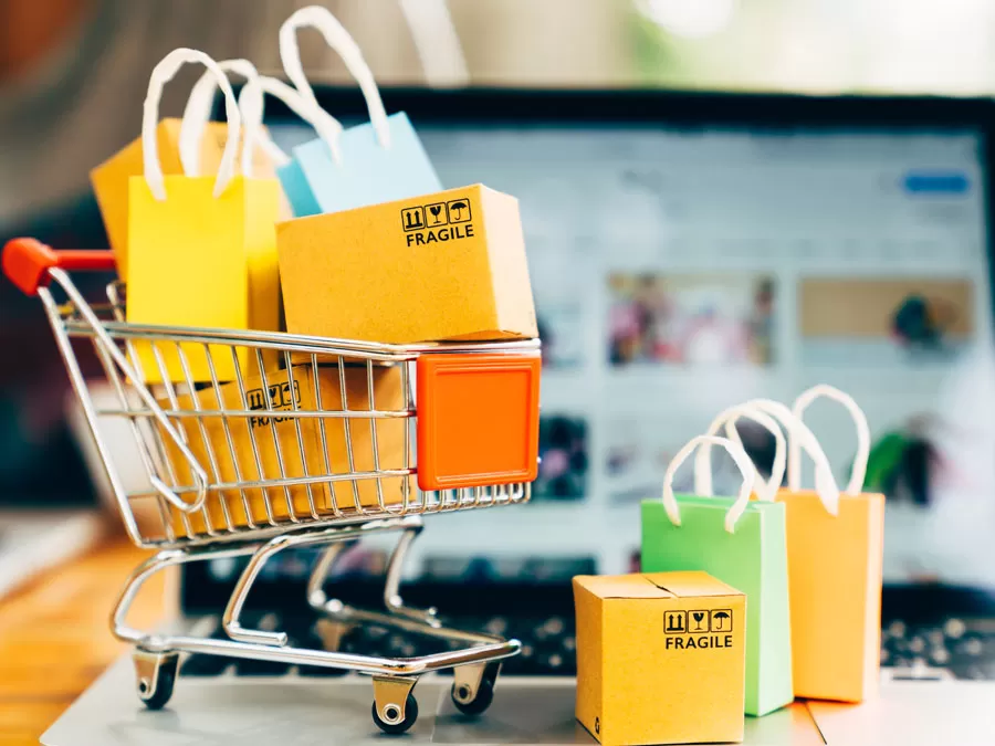 ecommerce customer experience depiction small shopping cart boxes on laptop