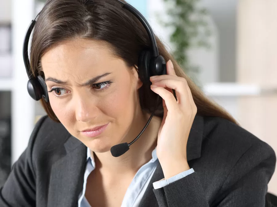 dubious customer service agent looking at agent profile on computer