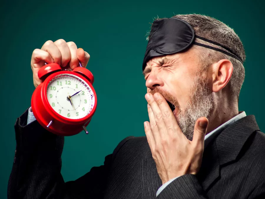 employee self-care sleep call center worker holding alarm clock