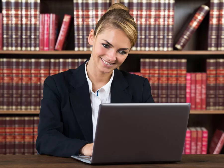 outsource to the Philippines legal support outsourcing agent reading legal documents on laptop