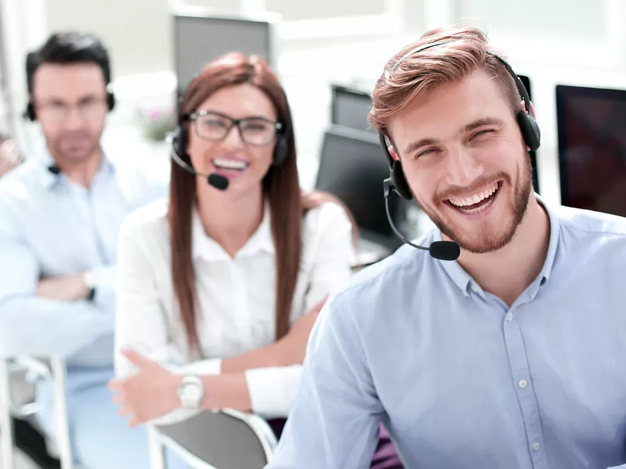 smiling outsourcing call center agents at the office